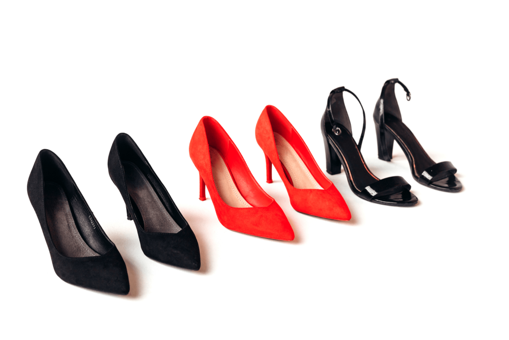 three pairs of high heels —displayed on a white background, featuring pumps and strappy styles.